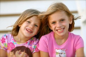Two young girls smile in Leawood, KS.