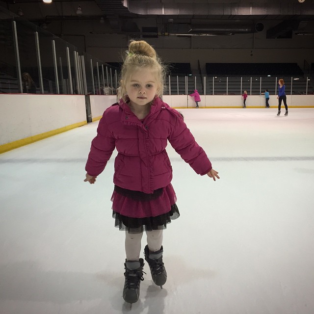 A young girl in purple skating on ice at AZ Ice in Peoria, AZ