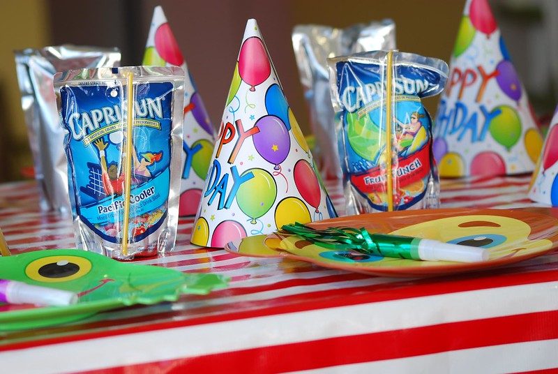 A kids party table with party hats, favors, and Capri Sun in Chicago, IL