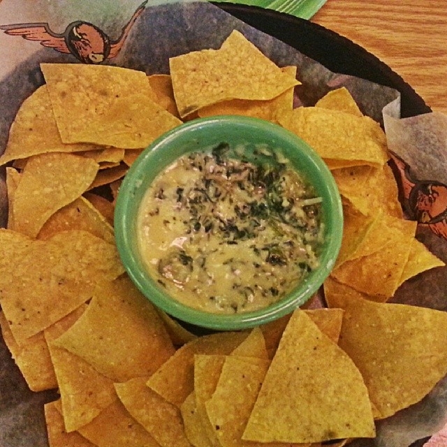 A plate of spinach artichoke dip and tortilla chips in Glenview, IL