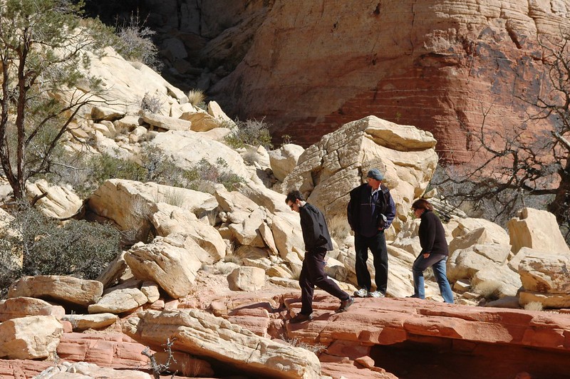 3 people walking through Red Rock Canyon National Conservation Area in Las Vegas, NV