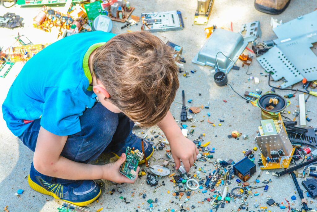 A child using parts to construct a circuit board during STEM education