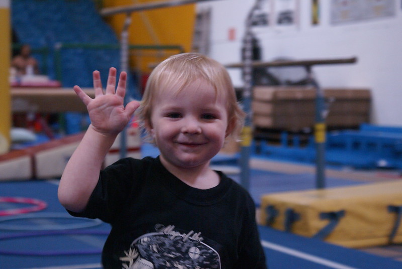 A small cute child waving at a Mommy & Me class in Warrenville, IL