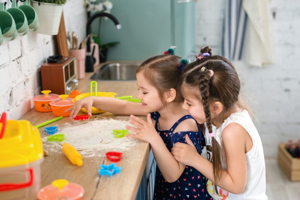 Two young girls baking at a cooking class in Glenview, IL