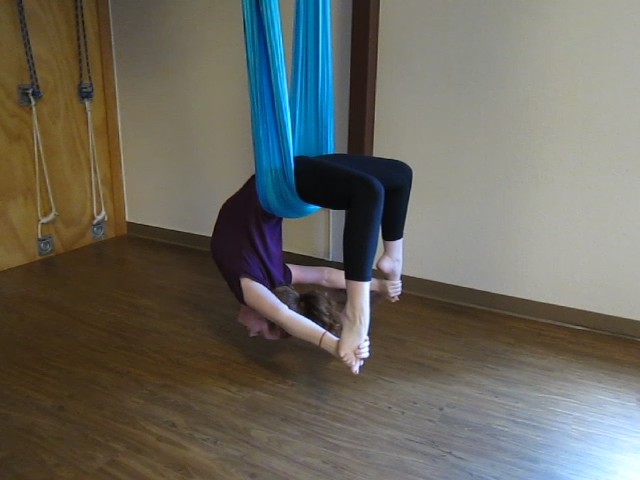 A young child doing aerial yoga at a class near Warrenville, IL