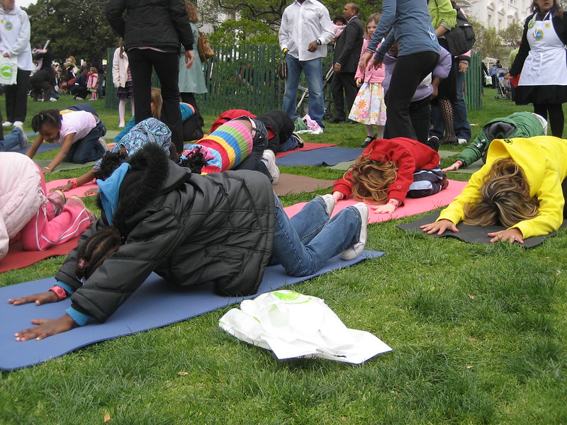 A group of children doing yoga in a park in Lone Tree, CO