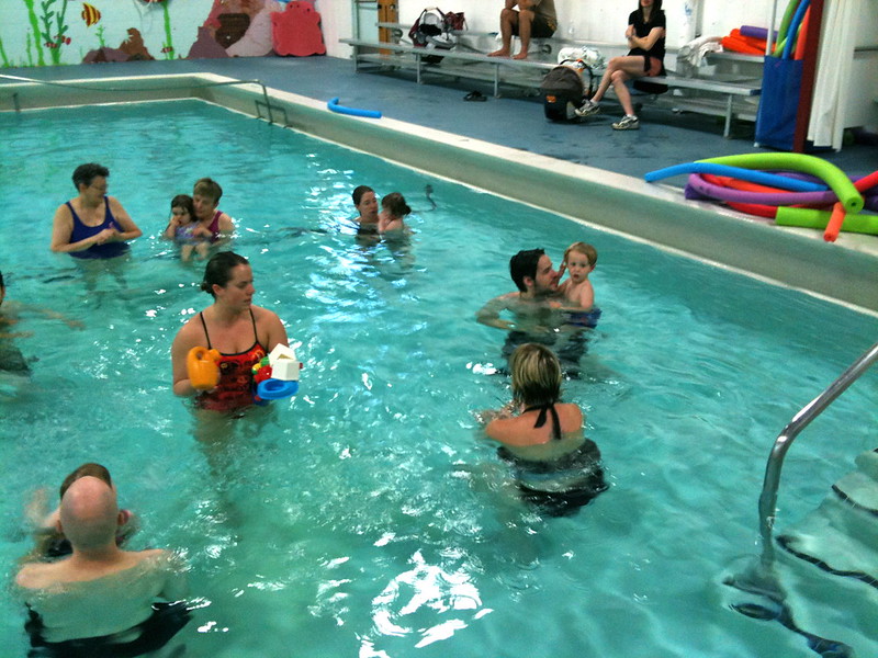 Families in a swimming pool at a water safety class in Colorado.