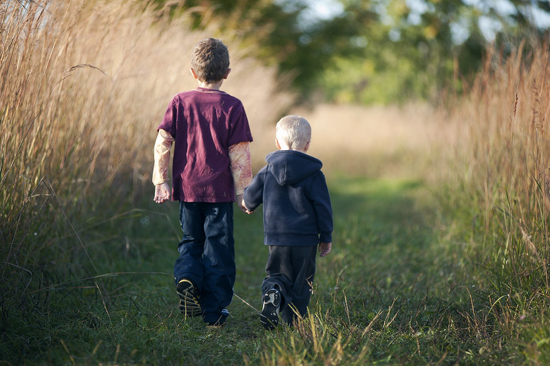 Two children hiking near a field in Ellisville, MO
