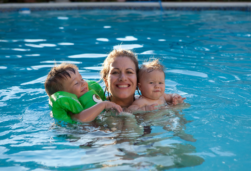A mother hugging two children in a pool in Chicago, IL