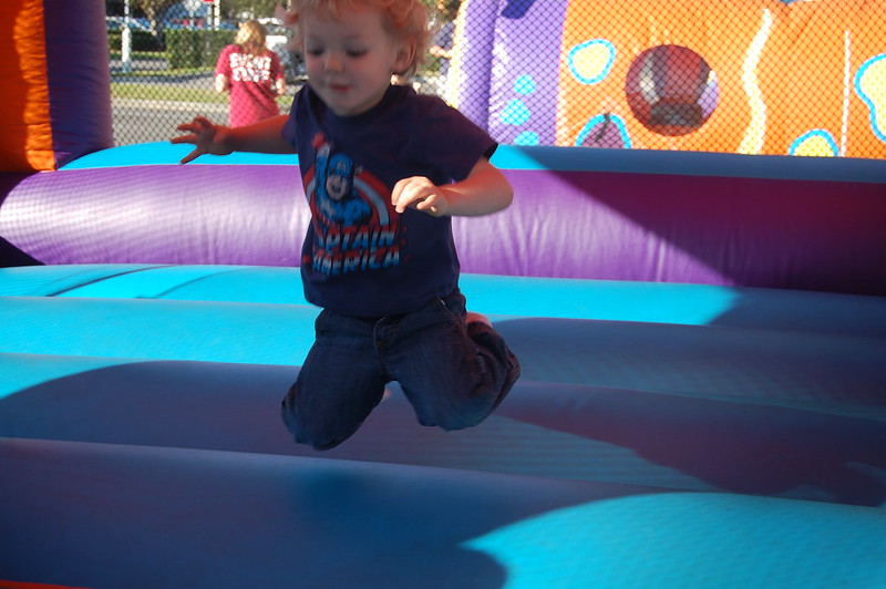 Young child laughing while bouncing in an inflatable castle