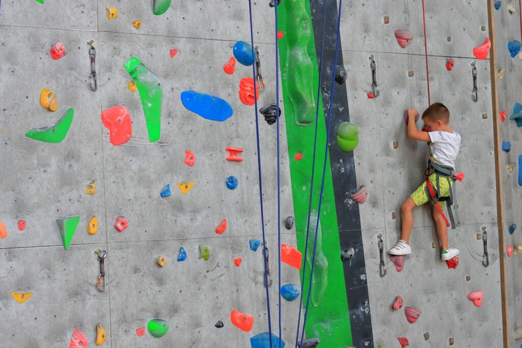 A young child on a rock climbing wall in Mount Laurel, NJ