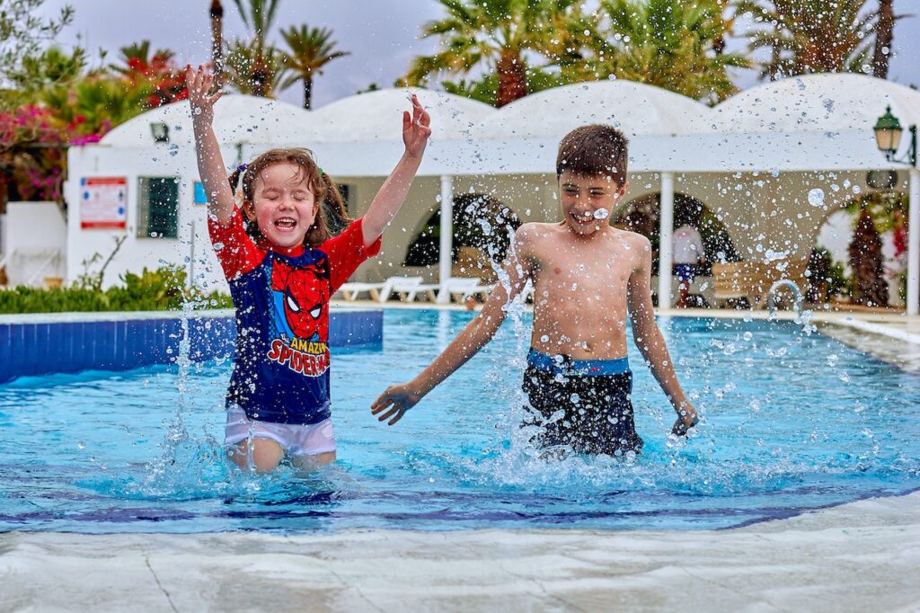 Two children swimming in a splash pool in Mesa, AZ