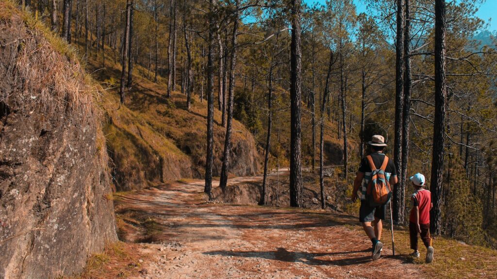 A man and a child hiking on a trail on a hill near Woodbridge, VA