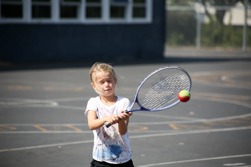 A young child hitting a tennis ball during a lesson in Oklahoma City.