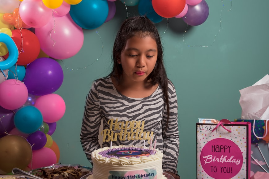 A girl blows out a candle on a birthday cake in South Barrington, IL