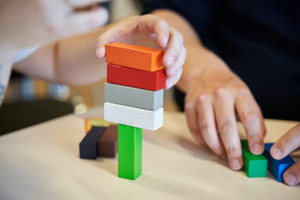 A young child playing with blocks as a critical thinking activity