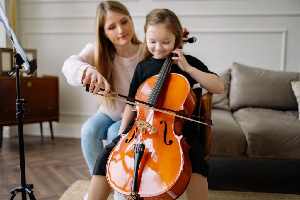 A woman teaches a child how to play the cello in Norcross, GA