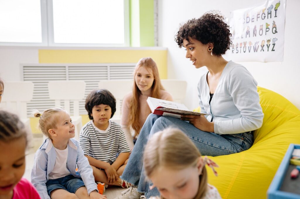 Woman reads to a group of children at a language class in Duluth, GA