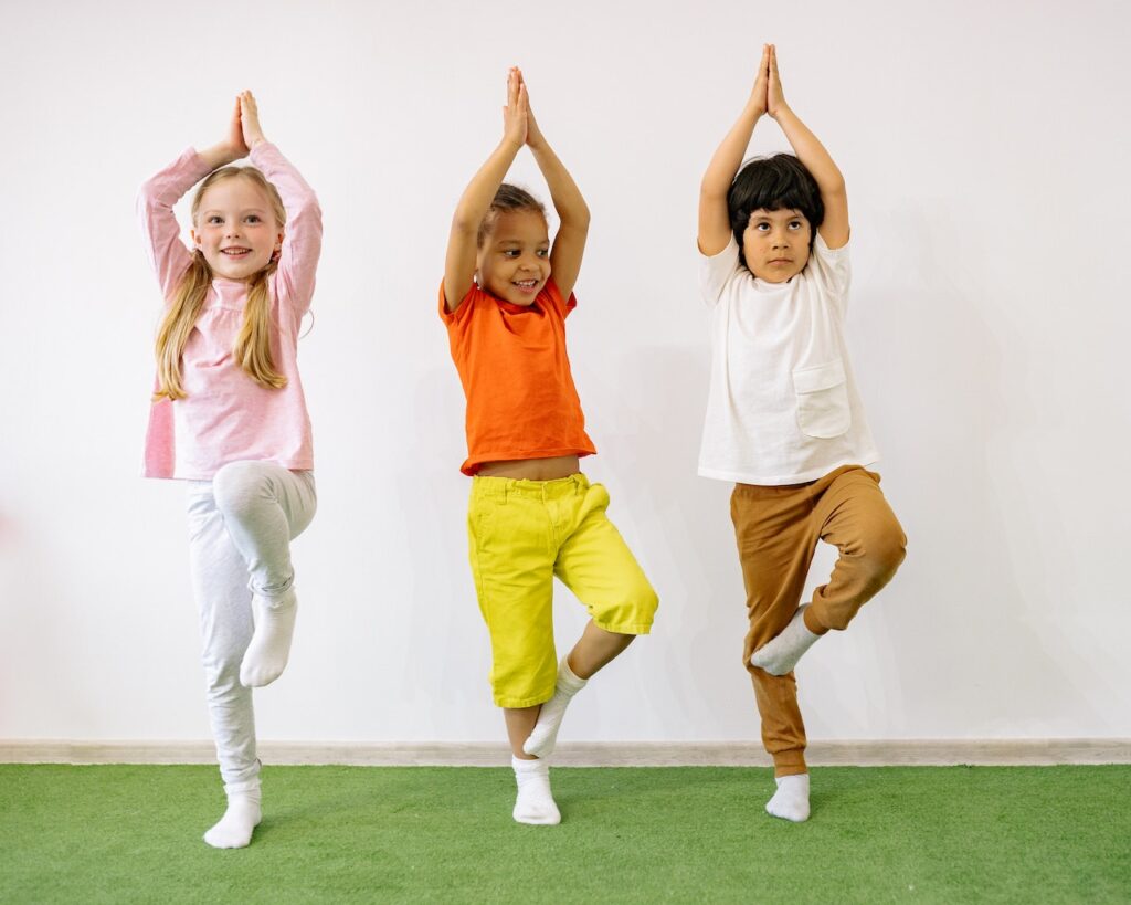 Three children in a yoga pose at a class in Chandler, AZ