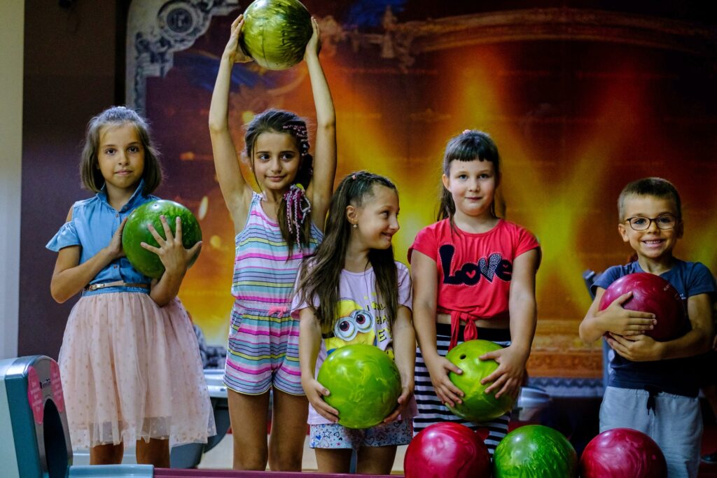 Kids preparing to go bowling at a family-friendly party venue