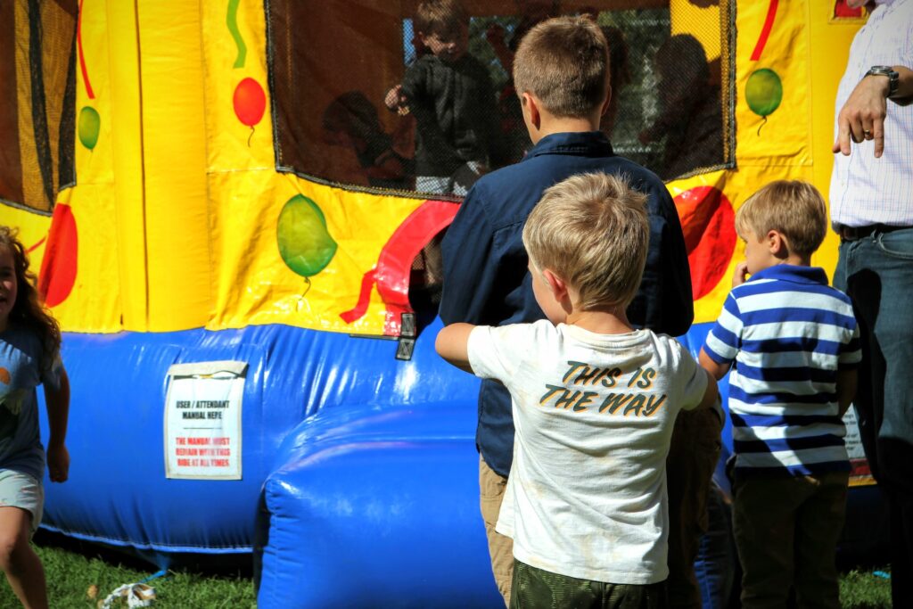 Children waiting in line to enter a bouncy castle in Texas
