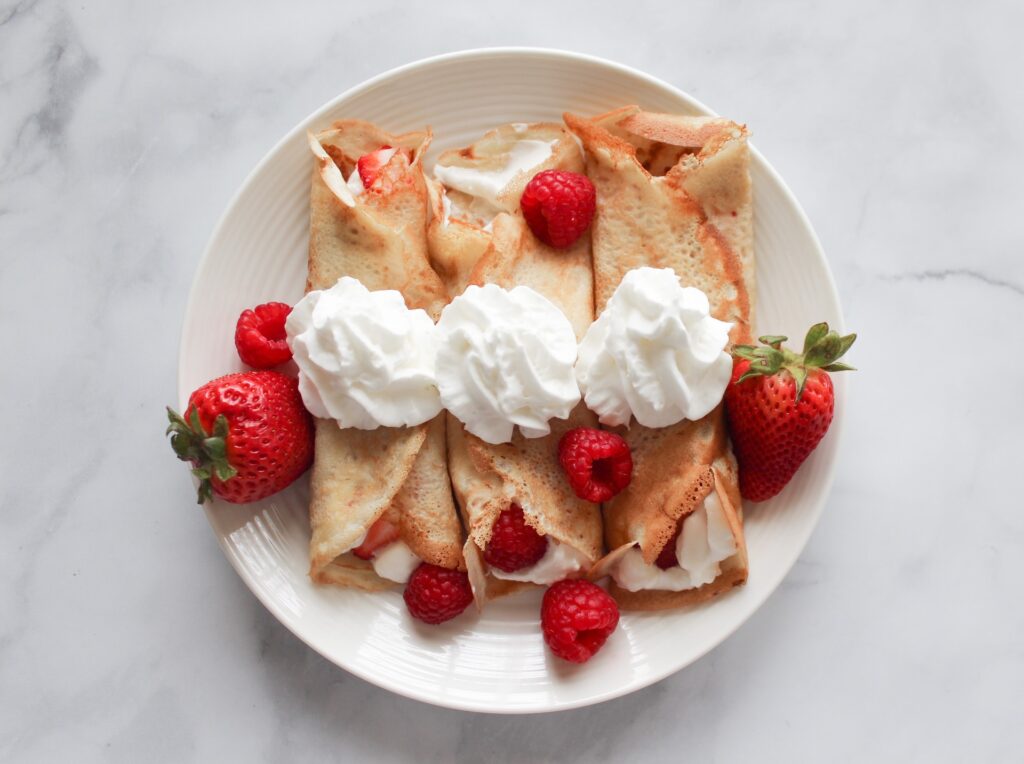 A delicious looking plate of strawberry crepes