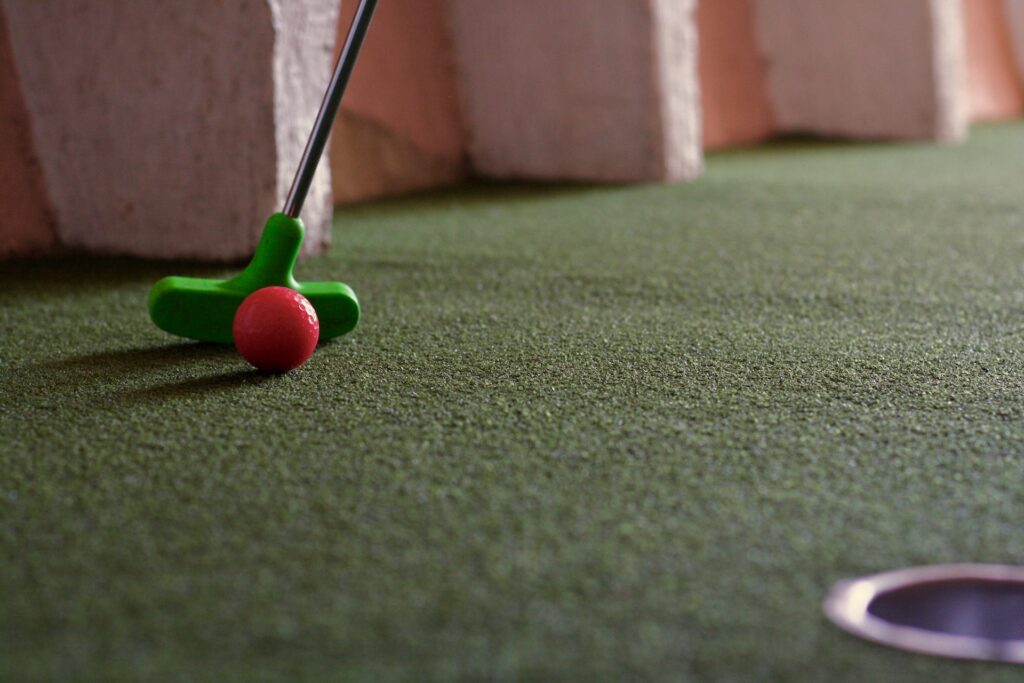 A child about to make a putt at a mini golf course in Mesa, AZ