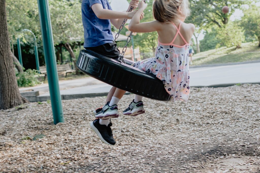Children on a swingset in a park in Allen, TX