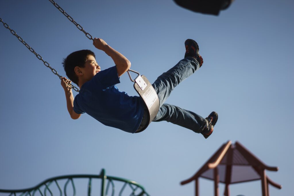 A child swinging at a playground in New Jersey.