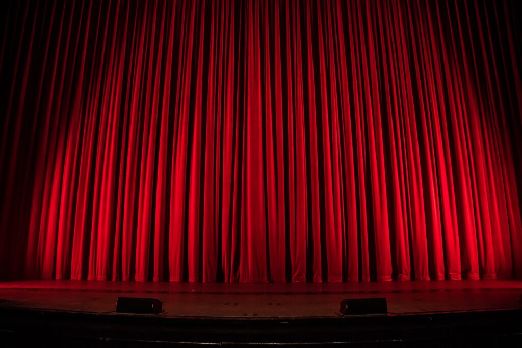 A red curtain drawn on a stage in Allen, TX