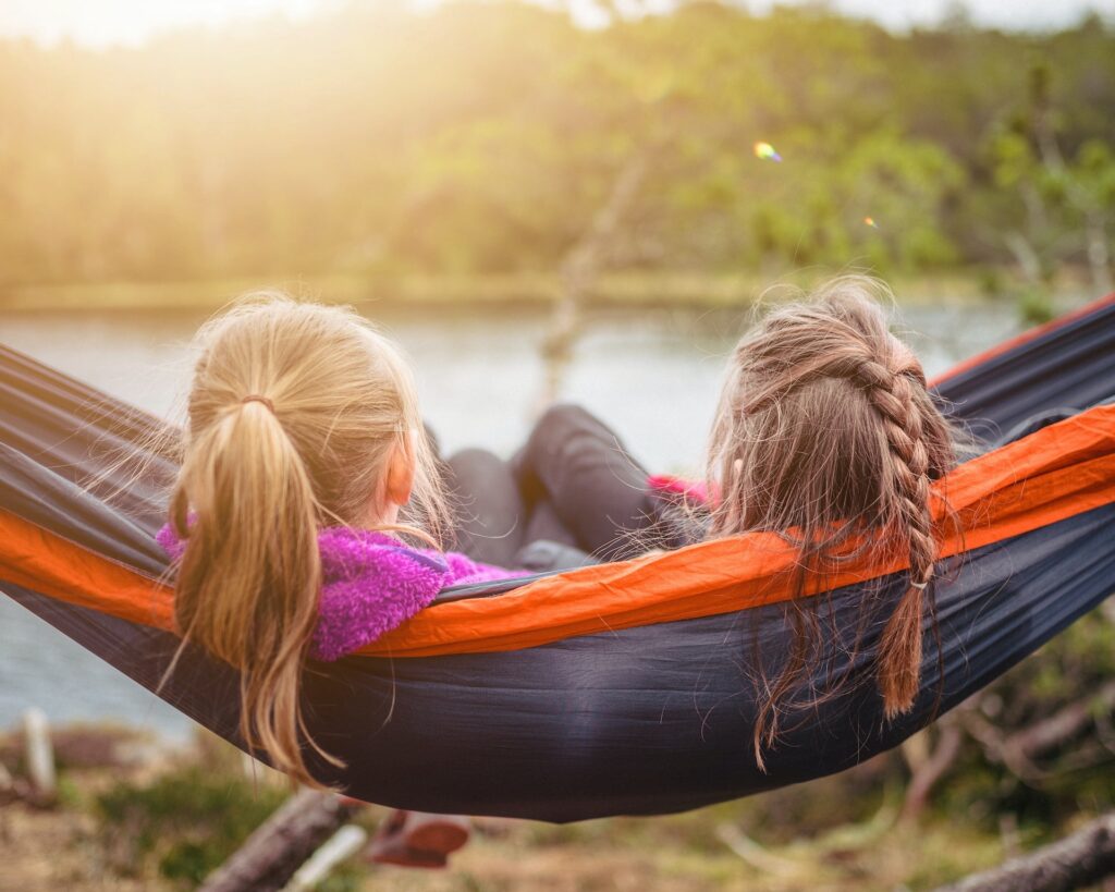 Children in a hammock by a lake, enjoying a staycation in Bridgewater, NJ