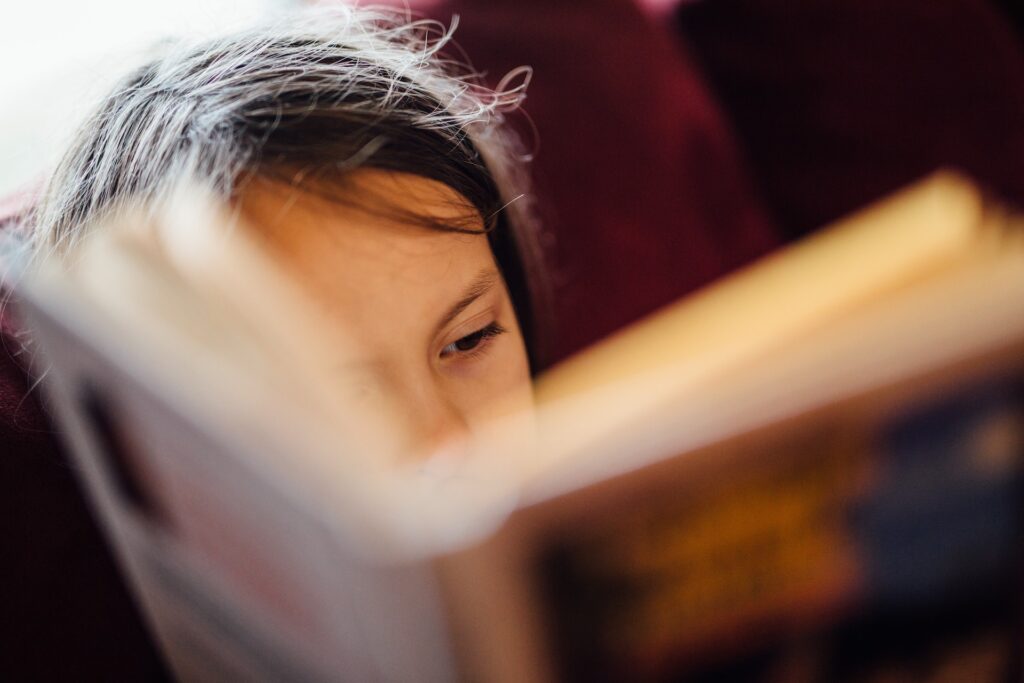 A child reading a book in a language class in Mount Laurel, NJ