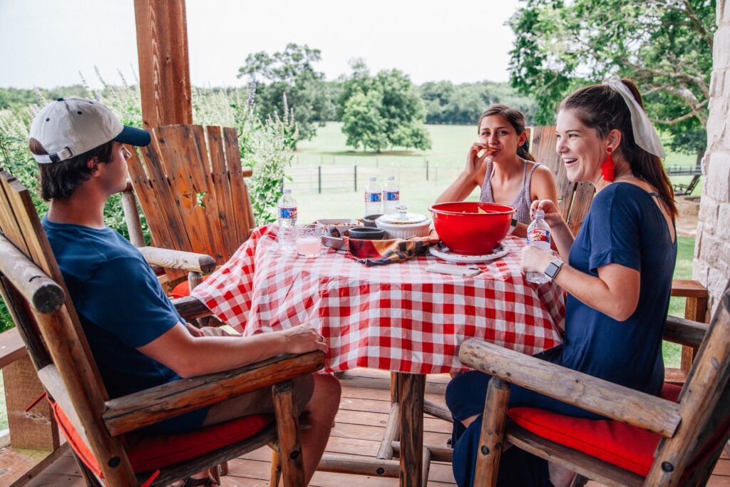 A family enjoying a meal on a porch in McKinney, TX