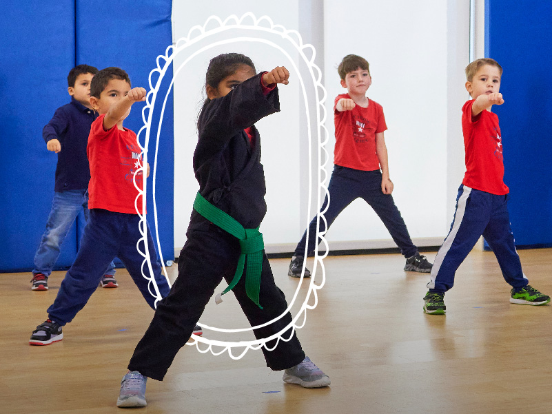 A gym full of toddlers learning self defense and martial arts during a Crème de la Crème class.