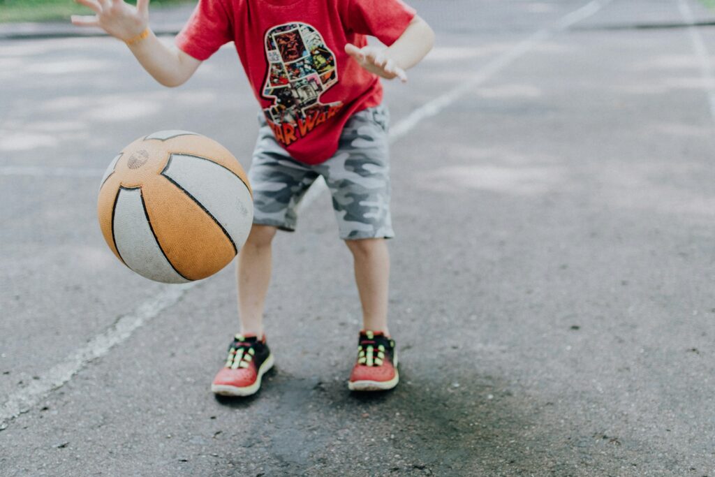 A child dribbling a basketball on a court in Goodyear, AZ