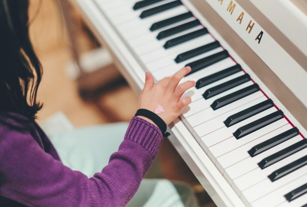 A child at the piano during a music class in Las Vegas, NV
