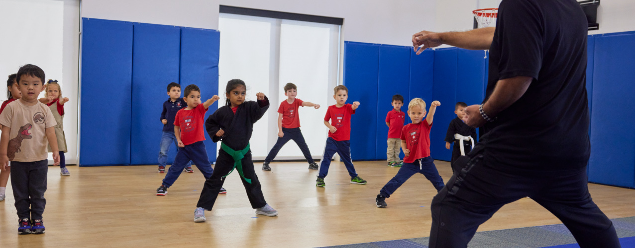 A gym full of toddlers learning self defense and martial arts during a Crème de la Crème class.