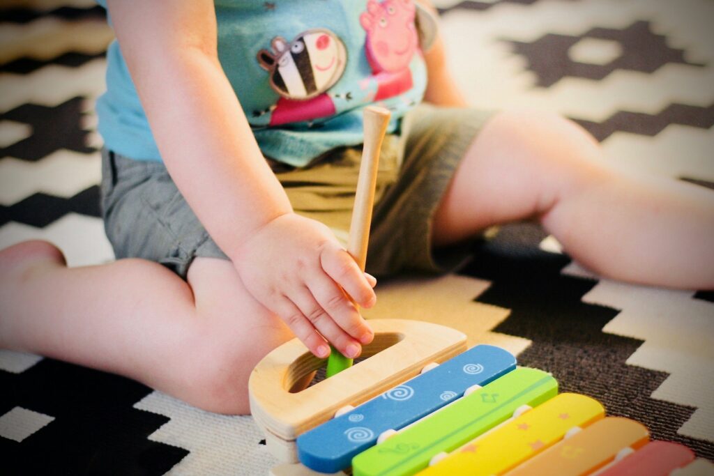 A child playing a small xylophone.