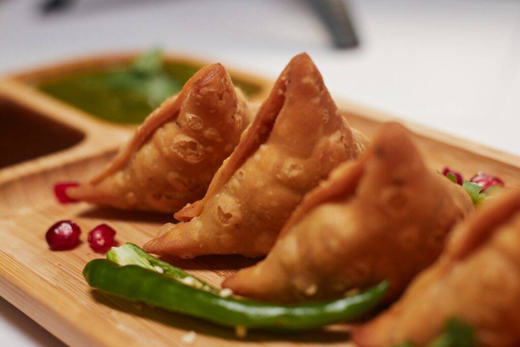 3 samosas on a plate at an Indian restaurant in Oklahoma City.