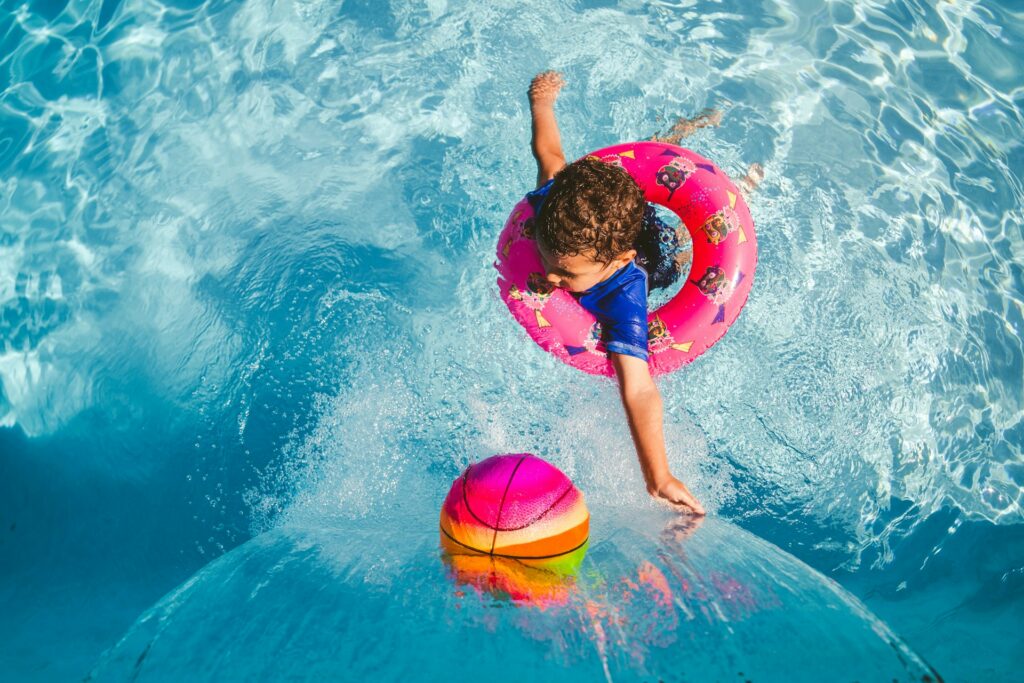 A child in an innertube near a waterfall in a pool in Warrenville, IL