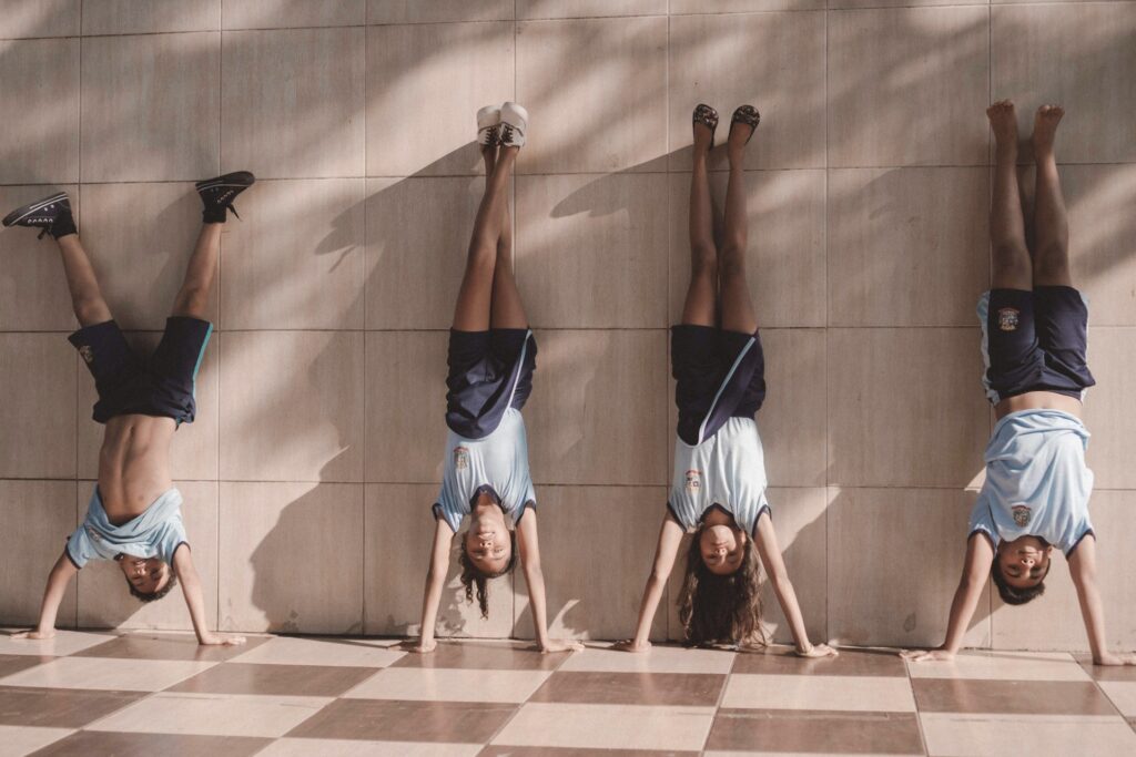 4 yogis doing handstands against the wall in Westmont, IL