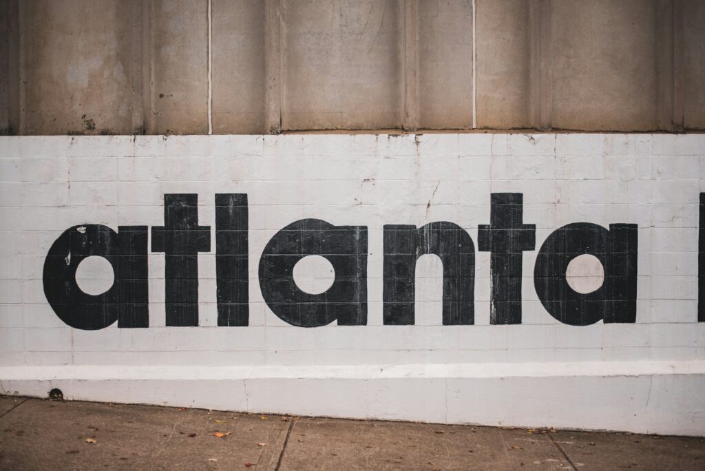 The word Atlanta painted on a board by an art installation.