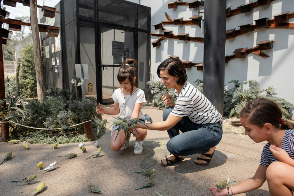 Woman and daughter petting birds