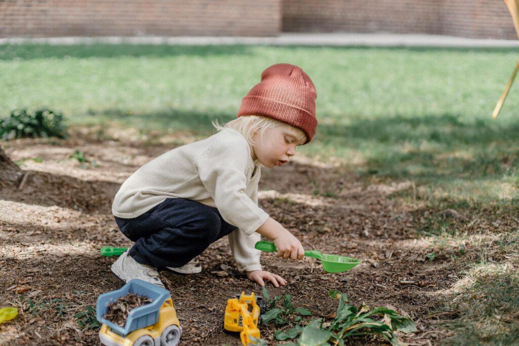 Child gardening outside in a vegetable garden