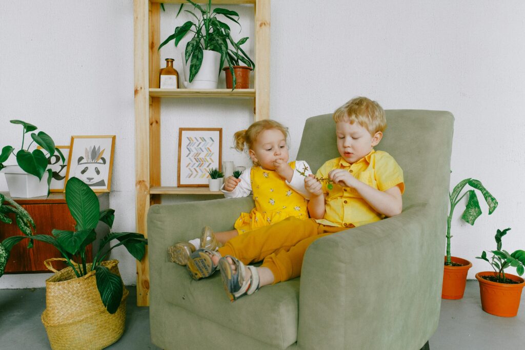 2 children sitting in a chair at a hotel