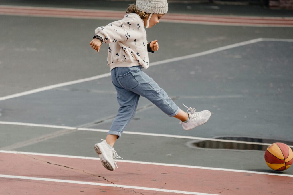 Girl playing on basketball court