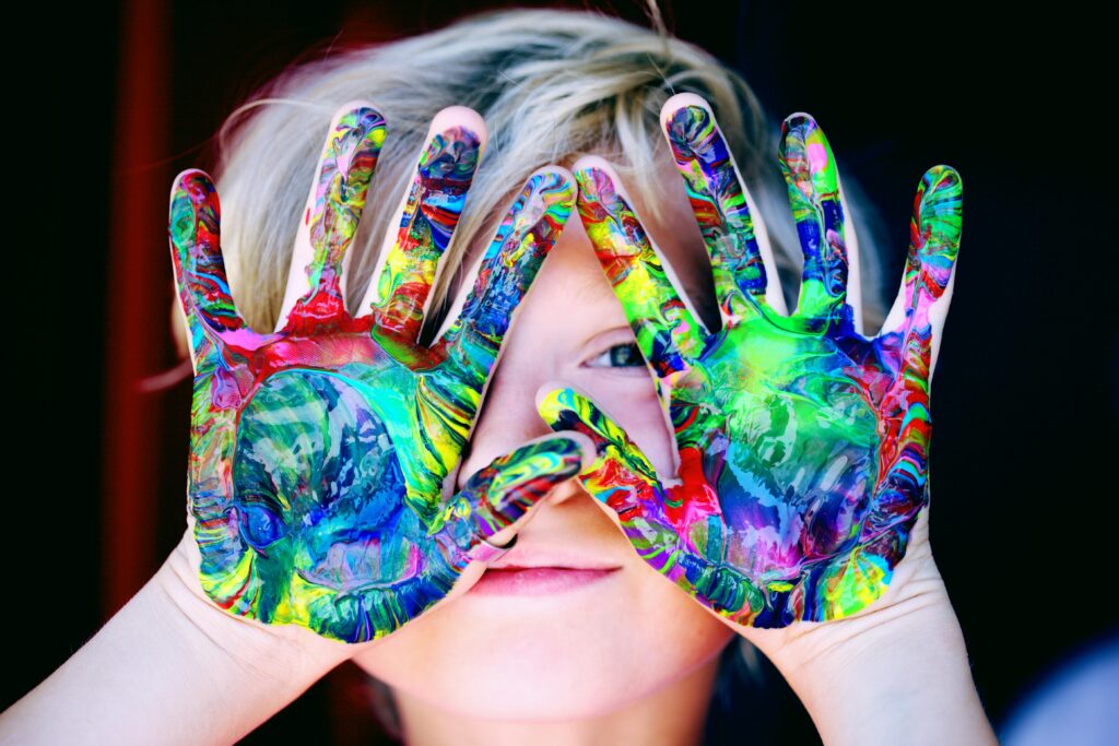 a child with hand painting resembling painting