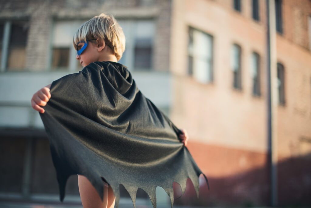 boy wearing black Batman cape