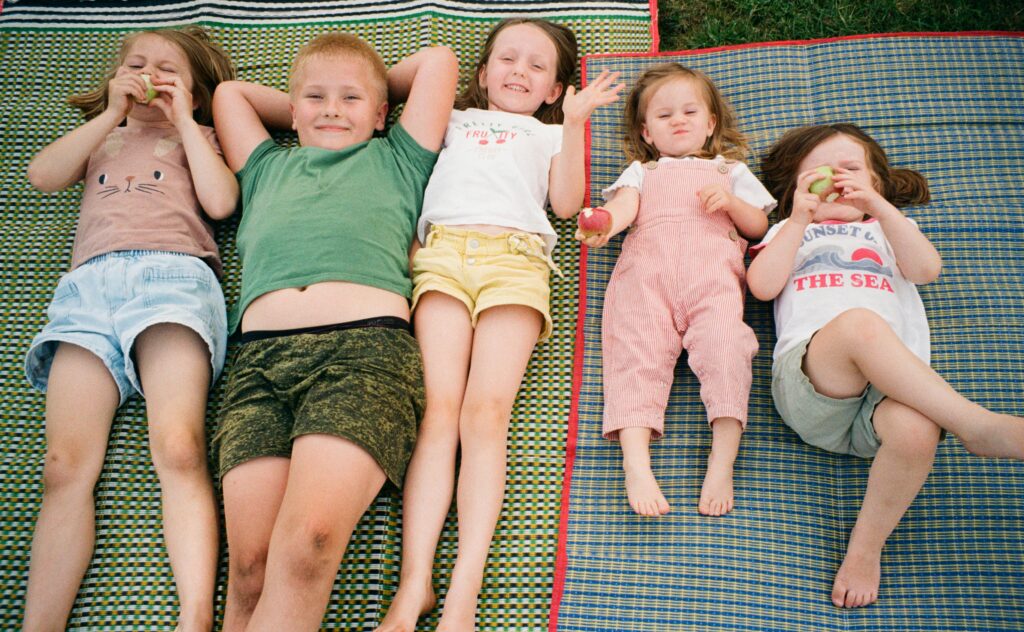 Children Enjoying a Picnic on a Sunny Day