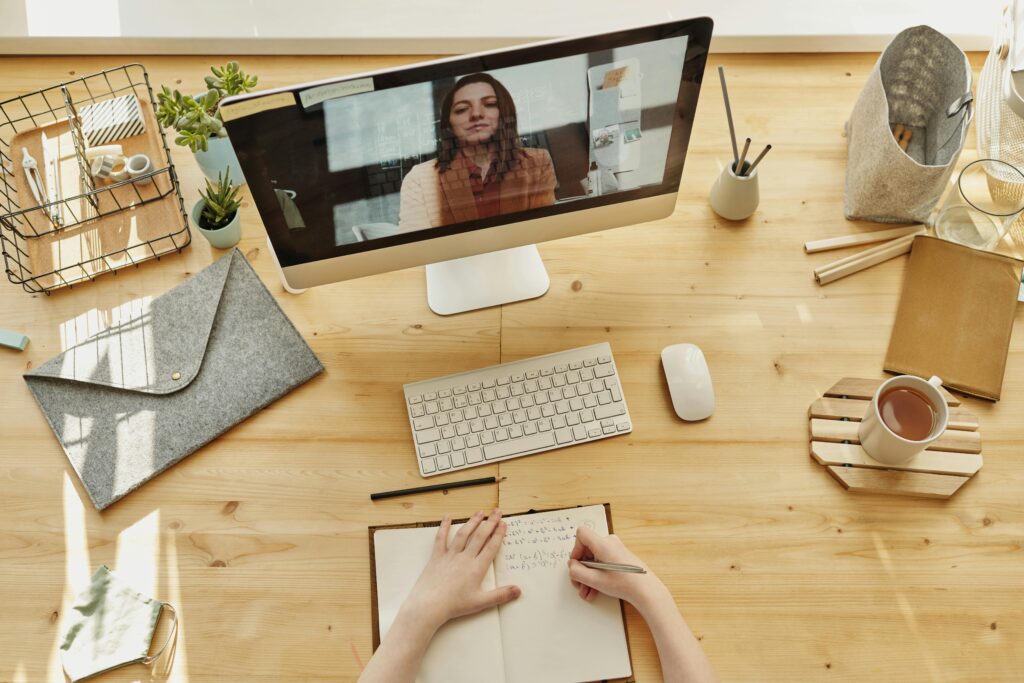 Child learning long distance with teacher on screen